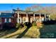 Brick house with a large front porch and mature landscaping at 1506 Dallas Cherryville Hwy, Dallas, NC 28034