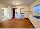 Kitchen with white cabinetry, wood flooring and modern appliances at 1506 Dallas Cherryville Hwy, Dallas, NC 28034