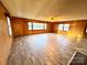 Spacious living room with wood-paneled walls and hardwood floors at 1506 Dallas Cherryville Hwy, Dallas, NC 28034