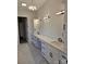 Bathroom featuring double sinks, marble flooring, white cabinets, and modern lighting fixtures at 13217 Terrace Court Dr, Charlotte, NC 28278