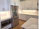 A kitchen with white cabinets, granite countertops, and stainless steel appliances at 13217 Terrace Court Dr, Charlotte, NC 28278