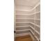 View of a bright, clean pantry with multiple shelves for ample storage, and wood flooring at 13217 Terrace Court Dr, Charlotte, NC 28278