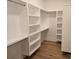 Spacious walk-in closet with custom shelving and wooden floors at 13217 Terrace Court Dr, Charlotte, NC 28278