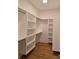 Large walk-in closet with plenty of shelving, hanging space, and hardwood floors at 13217 Terrace Court Dr, Charlotte, NC 28278