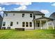 Exterior of home showcasing the backyard with a stone fire pit and covered porch at 2027 Cedar Falls Dr # 75, Waxhaw, NC 28173