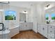 Bright bathroom featuring a garden tub, glass shower, and double vanity sinks at 2027 Cedar Falls Dr # 75, Waxhaw, NC 28173
