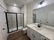 Bright bathroom features a glass enclosed shower, single vanity and wood look flooring at 2027 Cedar Falls Dr # 75, Waxhaw, NC 28173