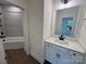 Bright bathroom features a tub with shower, single vanity and wood look flooring at 2027 Cedar Falls Dr # 75, Waxhaw, NC 28173
