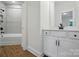 Modern, bright bathroom with tub and shower combination, white vanity and wood floor at 2027 Cedar Falls Dr # 75, Waxhaw, NC 28173