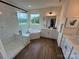 Bright bathroom features a soaking tub, glass enclosed shower, double vanity and wood look flooring at 2027 Cedar Falls Dr # 75, Waxhaw, NC 28173