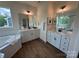 Bright bathroom features a soaking tub, glass enclosed shower, double vanity and wood look flooring at 2027 Cedar Falls Dr # 75, Waxhaw, NC 28173