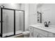 Bathroom featuring a tiled walk-in shower, white vanity, and hardwood flooring at 2027 Cedar Falls Dr # 75, Waxhaw, NC 28173