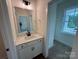 Bright bathroom featuring a modern vanity, neutral color palette, and open closet space at 2027 Cedar Falls Dr # 75, Waxhaw, NC 28173