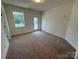 Neutral bedroom featuring carpet flooring and a door leading to the exterior at 2027 Cedar Falls Dr # 75, Waxhaw, NC 28173