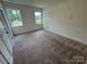 Bright, spacious bedroom with two windows, neutral carpet, and trim at 2027 Cedar Falls Dr # 75, Waxhaw, NC 28173