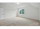 Bright, spacious bedroom with plush carpet, neutral walls, and large window at 2027 Cedar Falls Dr # 75, Waxhaw, NC 28173