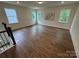 Spacious bonus room with hardwood floors, ample natural light, and neutral paint for flexible living space at 2027 Cedar Falls Dr # 75, Waxhaw, NC 28173