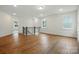 Bonus room with windows, hardwood floors, and dark railing at 2027 Cedar Falls Dr # 75, Waxhaw, NC 28173