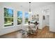 Bright dining area with large windows providing natural light, modern light fixture and hardwood floors at 2027 Cedar Falls Dr # 75, Waxhaw, NC 28173