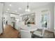 Eat-in kitchen with a dining area with modern light fixture connecting to a spacious living area at 2027 Cedar Falls Dr # 75, Waxhaw, NC 28173