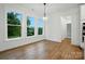 Bright dining room with large windows, modern light fixture, and hardwood floors at 2027 Cedar Falls Dr # 75, Waxhaw, NC 28173