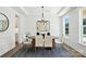 Modern dining room with dark wood table, white chairs, and an elegant rug at 2027 Cedar Falls Dr # 75, Waxhaw, NC 28173
