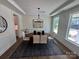 Formal dining room featuring wood floors, modern lighting, and large windows at 2027 Cedar Falls Dr # 75, Waxhaw, NC 28173