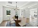 Formal dining room with wainscoting, modern chandelier, and views of the front yard at 2027 Cedar Falls Dr # 75, Waxhaw, NC 28173