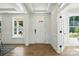 Bright entryway features wood floors, white trim, and a stylish front door with glass accents at 2027 Cedar Falls Dr # 75, Waxhaw, NC 28173