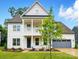 Charming two-story home with gray garage, covered porch and manicured landscaping at 2027 Cedar Falls Dr # 75, Waxhaw, NC 28173