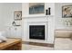 Close-up of a marble fireplace with white mantle, built-in cabinets, and modern decor at 2027 Cedar Falls Dr # 75, Waxhaw, NC 28173