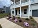 Charming two-story home showcasing a covered front porch and nicely landscaped yard at 2027 Cedar Falls Dr # 75, Waxhaw, NC 28173