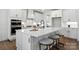 Modern kitchen features a large island, stainless steel appliances, and white cabinetry at 2027 Cedar Falls Dr # 75, Waxhaw, NC 28173