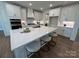 A gourmet kitchen with large quartz island, stainless appliances, and custom white cabinetry, perfect for entertaining at 2027 Cedar Falls Dr # 75, Waxhaw, NC 28173
