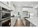 Gourmet kitchen with stainless steel appliances, quartz countertops, and custom white cabinetry at 2027 Cedar Falls Dr # 75, Waxhaw, NC 28173