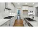Modern kitchen with white cabinets, stainless steel sink, and hardwood floors at 2027 Cedar Falls Dr # 75, Waxhaw, NC 28173