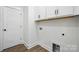 Laundry room with white cabinets and hardwood flooring at 2027 Cedar Falls Dr # 75, Waxhaw, NC 28173