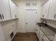 Laundry room featuring overhead cabinets, sink, and gray counter tops at 2027 Cedar Falls Dr # 75, Waxhaw, NC 28173