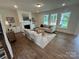 Bright living room featuring a fireplace, comfortable seating, and large windows at 2027 Cedar Falls Dr # 75, Waxhaw, NC 28173