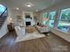Cozy living room with a fireplace, plush seating, and ample natural light at 2027 Cedar Falls Dr # 75, Waxhaw, NC 28173