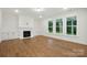 Living room featuring a cozy fireplace, custom built ins, and large windows to the porch at 2027 Cedar Falls Dr # 75, Waxhaw, NC 28173