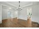 Open-concept living room with hardwood floors and elegant trim work at 2027 Cedar Falls Dr # 75, Waxhaw, NC 28173
