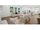 Bright and open living area flowing into the kitchen and dining space, featuring large windows at 2027 Cedar Falls Dr # 75, Waxhaw, NC 28173
