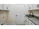 Well-lit mud room with utility sink, gray countertops, and white cabinetry at 2027 Cedar Falls Dr # 75, Waxhaw, NC 28173