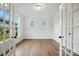 Bright office space with wood floors, white walls, and natural light from the glass doors and windows at 2027 Cedar Falls Dr # 75, Waxhaw, NC 28173