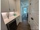Walk-in pantry featuring white cabinetry, quartz countertop, and a wine cooler for storage at 2027 Cedar Falls Dr # 75, Waxhaw, NC 28173