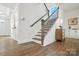 Staircase with wood floors, wooden handrail, and black iron balusters at 2027 Cedar Falls Dr # 75, Waxhaw, NC 28173
