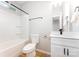 Bathroom featuring a shower-tub combo, toilet, and vanity with white cabinets and black hardware at 1011 Indiana St, Kannapolis, NC 28083