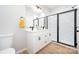 Modern bathroom with double vanity, white cabinets, black hardware, and glass-enclosed shower at 1011 Indiana St, Kannapolis, NC 28083