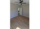 This bedroom features wood-look flooring, a ceiling fan, and an open doorway to another room at 1011 Indiana St, Kannapolis, NC 28083